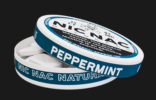 Nic Nac peppermint nicotine pouches with warning labels on a black background