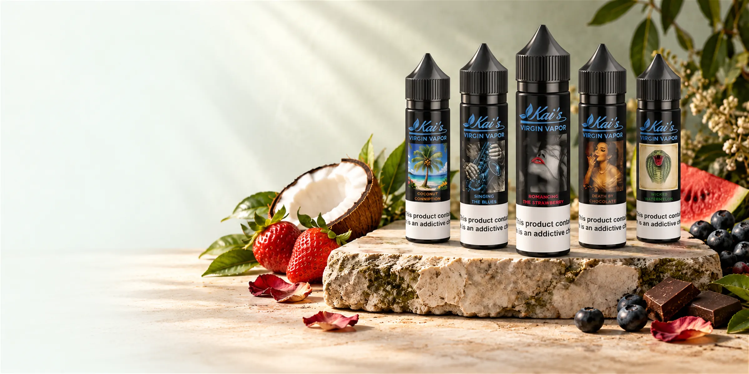 Five Kai's Virgin Vapor 60 ml organic e-liquid bottles on a moss-edged stone with strawberries, coconut, watermelon, blueberries and dark chocolate